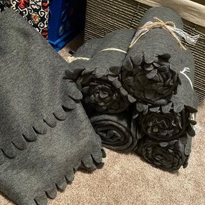 Dark gray fleece blankets with scalloped edges